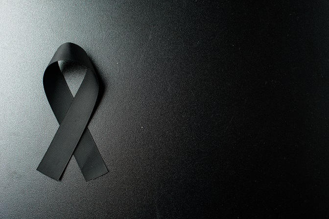 top view black bow as mourning symbol dark wall
